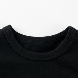 Neckline detail of a girls black cotton round neck short sleeve t-shirt with premium stitching