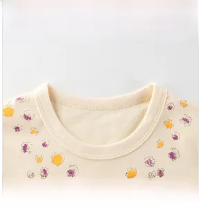 Détail du col rond côtelé et de l'imprimé floral sur un t-shirt en coton pour fille