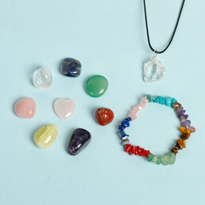 Natural crystal gift set featuring raw stones, beaded bracelet and quartz pendant
