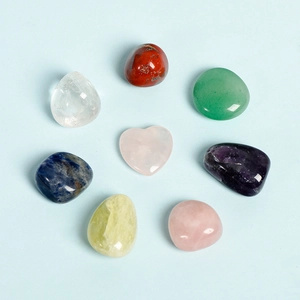 Set of 7 colorful polished chakra stones including a heart-shaped rose quartz crystal