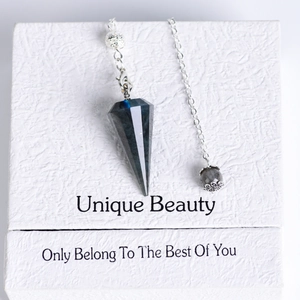 Natural labradorite crystal pendulum with blue flash and faceted cone on a gift box