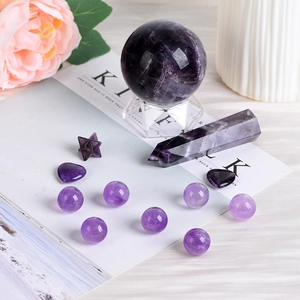 Natural amethyst crystal set with sphere prism and heart stones on elegant background
