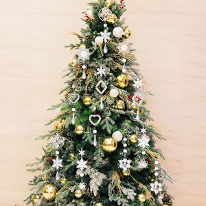Detailed view of clear acrylic snowflake and crystal ornaments on a festive Christmas tree