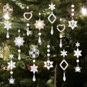 Detailed view of clear acrylic snowflake and heart ornaments on a festive Christmas tree