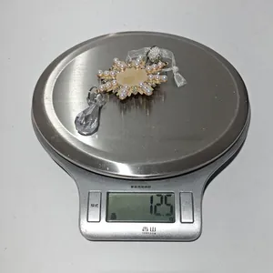 Detailed view of clear acrylic snowflake ornament with faux pearls on weighing scale