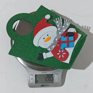 Detail showing a lightweight 28.5g Christmas snowman gift bag on a digital scale