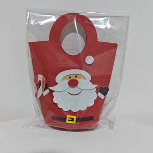 Detail of red felt Christmas gift bag featuring a 3D Santa Claus and candy cane design