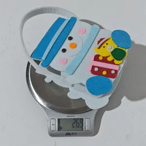 Detailed view of lightweight Christmas felt gift bag weighing 26.9g on a digital scale
