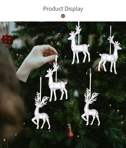 Close-up of clear acrylic Christmas reindeer hanging ornaments on a festive tree