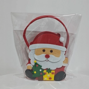 Detail view of a red felt Christmas gift bag featuring a 3D Santa Claus and tree