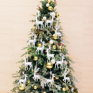 Set of 12 silver reindeer ornaments hanging on a decorated Christmas tree for festive decor
