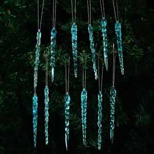 Close-up of 12 blue acrylic icicle ornaments with spiral texture on a green Christmas tree