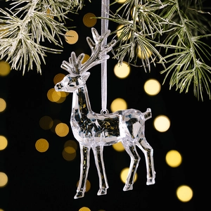 Detailed shot of a faceted transparent acrylic elk ornament with light silk hanging ribbon