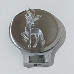Detailed view of lightweight acrylic Christmas reindeer pendant weighing 23.9g on scale