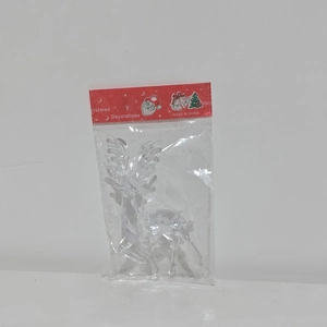 Macro shot of clear acrylic Christmas reindeer charm in red festive card packaging