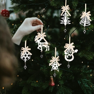 Detail of 6-piece white Christmas ornaments with ribbons and crystal pendants on a tree