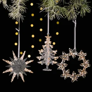 Close-up of three clear acrylic Christmas ornaments with champagne gold sequins