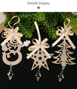 Detailed view of gold Christmas ornaments with snowman and tree shapes on pine branches