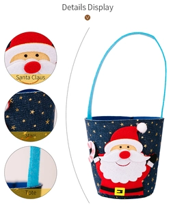 Detail view of denim Christmas gift bag featuring Santa Claus applique and gold stars