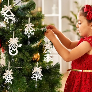 Detailed view of white Christmas tree ornaments with elegant bows and crystal pendants