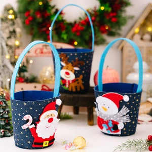 Three Christmas felt gift baskets with Santa, elk and snowman designs on blue fabric