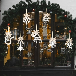 Detailed view of white festive ornaments including snowflakes and reindeer with crystal drops