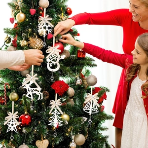 Family decorating Christmas tree with white wooden snowflake and reindeer ornaments