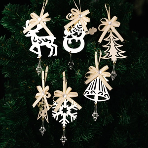 Detailed view of 6-piece cream Christmas iron ornaments with crystal drops on tree