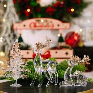 Macro detail of acrylic Christmas reindeer and tree ornaments with gold sequins