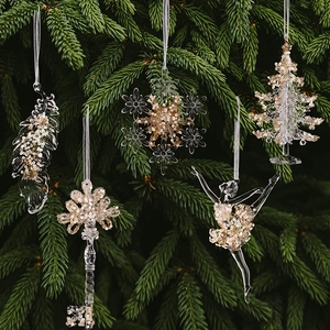 Detailed view of clear acrylic Christmas ornaments set with shimmering gold sequins