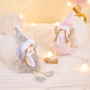 Detail of plush Christmas angel dolls in pink and grey with sequin wings and knit hats