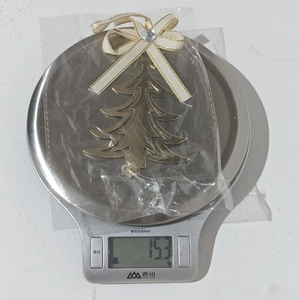 Detailed view of a gold Christmas tree iron ornament with bow and 15.3g weight display