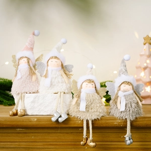 Detailed view of four plush Christmas angel dolls with glitter wings on a wooden table