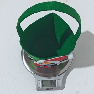 Detail view of a green felt Christmas candy bag with snowman patch weighing 35.2g