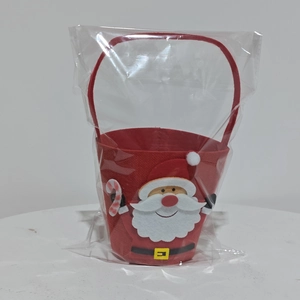 Detailed view of Santa Claus felt candy bag with handle in plastic packaging