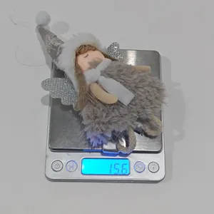 Detailed close-up showing the precise weight of a pink plush angel Christmas ornament