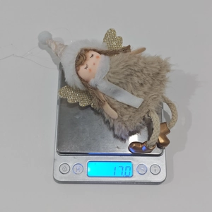 Pink plush angel hanging decoration on electronic scale weighing 17.0 grams