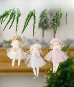 Three plush angel doll ornaments with sparkly hats hanging on a green Christmas tree branch