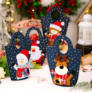 Set of four blue denim Christmas gift bags featuring Santa, snowman, elk, and bear patches
