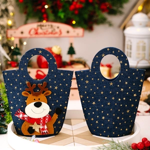 Detail of blue denim Christmas gift bag featuring reindeer applique and gold star patterns
