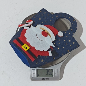 Detailed weight display of Santa denim Christmas gift bag showing 35.2 grams on a scale