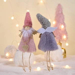Detail of plush Christmas angel ornaments with knit hats and heart sequins for tree decor