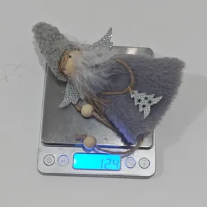 Detail of pink plush Christmas angel pendant with silver wings weighing 12.4g on scale