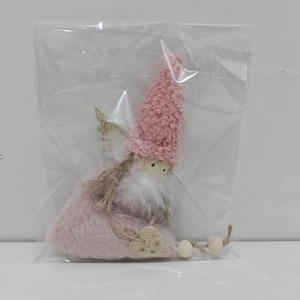 Detailed view of a pink plush gnome ornament with lamb wool hat and feather beard detail