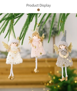 Detailed view of angel ornaments with golden wings on Christmas tree branches
