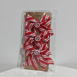 Three red and white candy cane striped Christmas bows with spiral center decorations