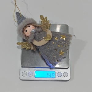 Digital scale showing the lightweight 14.8g plush pink angel Christmas tree ornament