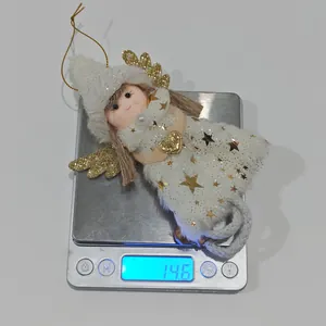 Detailed view showing a lightweight 14.6g plush angel Christmas tree ornament hanging on a scale