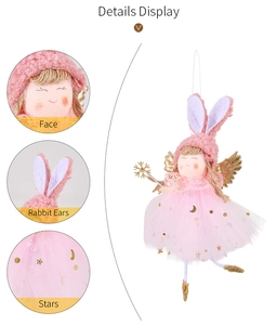 Detail view of pink angel ornament with rabbit ears and golden star sequins on tulle skirt