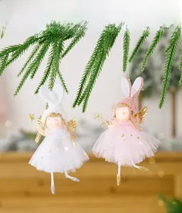 Detail of plush angel rabbit hanging ornaments with sequin wings on a Christmas tree